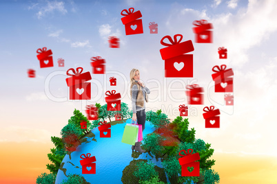 Composite image of blonde in winter clothes holding shopping bag