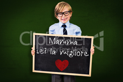 Composite image of cute pupil holding chalkboard