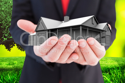 Composite image of businessman presenting with his hands