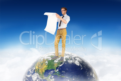 Composite image of geeky businessman reading large page