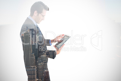 Composite image of businessman standing while using a tablet pc