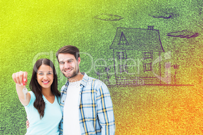 Composite image of happy young couple showing new house key