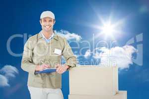 Composite image of happy delivery man writing on clipboard by ca