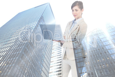 Composite image of confident businesswoman holding laptop