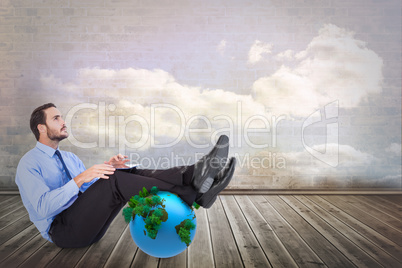 Composite image of businessman using tablet