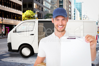 Composite image of happy delivery man holding cardboard box and