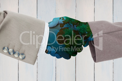 Composite image of side view of business peoples hands shaking