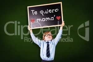 Composite image of cute pupil holding chalkboard