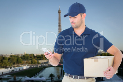 Composite image of delivery man using mobile phone while holding