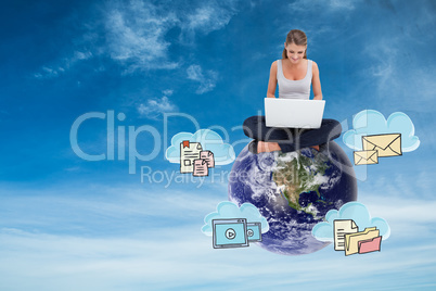 Composite image of cross-legged woman using a laptop