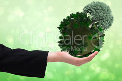 Composite image of businesswomans hand presenting