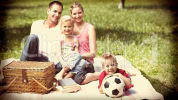 Parents and children relaxing at a picnic