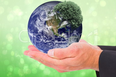 Composite image of businessman holding his hands out