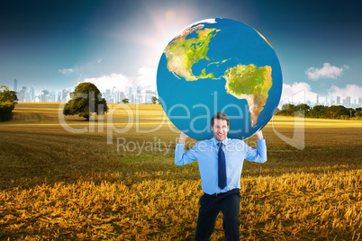 Composite image of businessman carrying the world