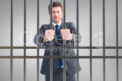 Composite image of businessman holding his hands out