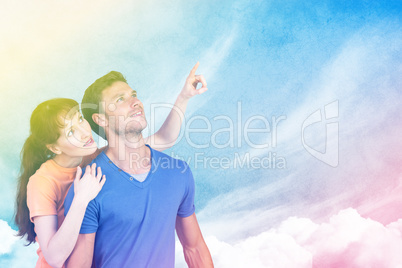 Composite image of happy couple looking upwards