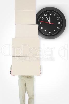 Composite image of delivery man carrying stacked boxes