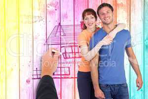 Composite image of happy couple looking at camera