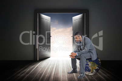 Composite image of thinking businessman sitting