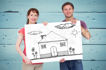 Composite image of couple holding a white sign