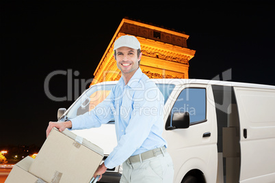 Composite image of confident delivery man pushing trolley of car