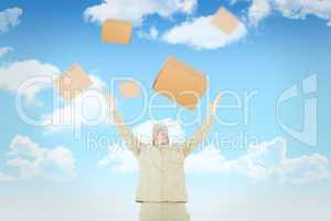 Composite image of excited delivery man with arms raised looking