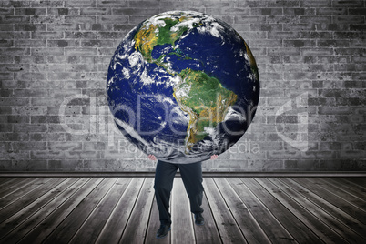 Composite image of businessman carrying the world