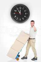 Composite image of delivery man with cardboard boxes gesturing t