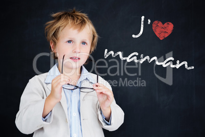 Composite image of cute pupil holding glasses