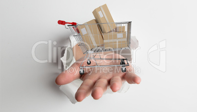 Composite image of hand bursting through paper