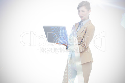 Composite image of confident businesswoman holding laptop