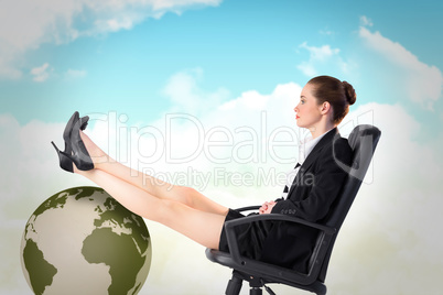 Composite image of businesswoman sitting on swivel chair with fe