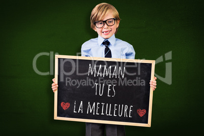 Composite image of cute pupil holding chalkboard