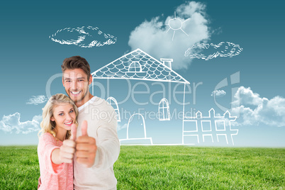 Composite image of attractive couple showing thumbs up to camera