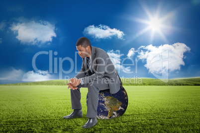 Composite image of thinking businessman sitting