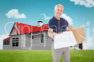 Composite image of happy delivery man holding cardboard box and