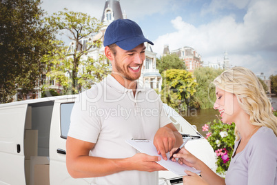 Composite image of happy delivery man getting signature from cus