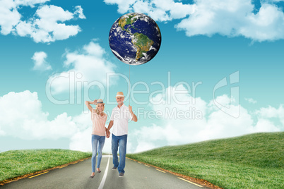 Composite image of happy couple walking holding hands