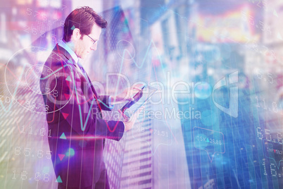 Composite image of businessman standing while using a tablet pc