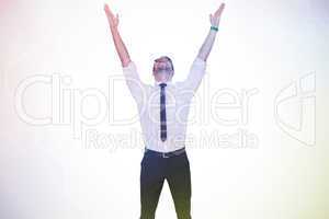 Composite image of smiling businessman cheering with his hands u