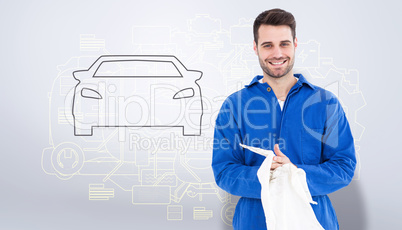 Composite image of male mechanic wiping hands with cloth