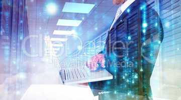 Composite image of businessman holding laptop