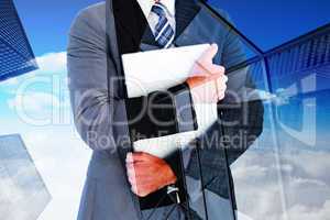 Composite image of businessman holding his laptop tightly