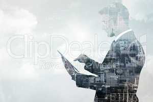 Composite image of mid section of a businessman touching tablet