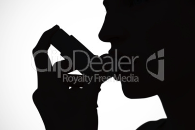 Composite image of blonde woman taking her inhaler