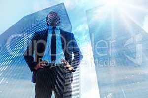 Composite image of happy businessman with hands on hips