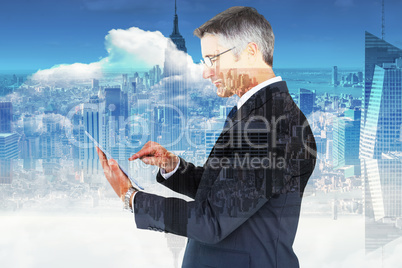 Composite image of mid section of a businessman touching tablet