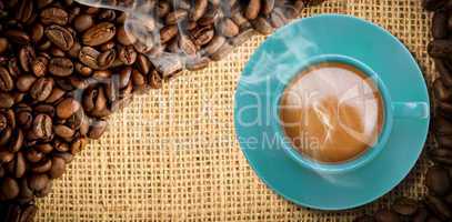 Composite image of blue cup of coffee