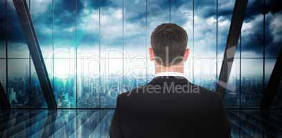 Composite image of  businessman looking in front of him in suit