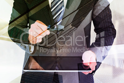 Composite image of businessman looking at tablet with magnifying